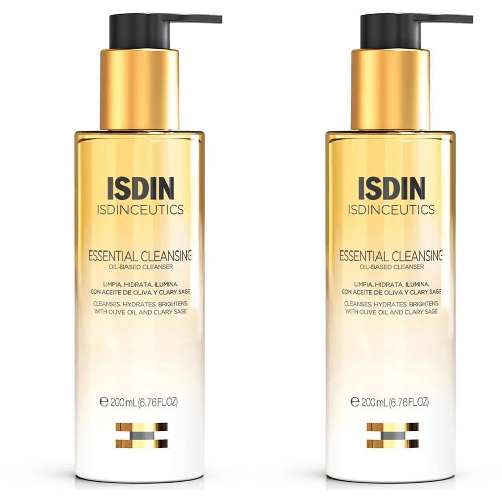 Zwei Flaschen ISDINCEUTICS Essential Cleansing Öl. Goldene Pumpköpfe, transparente Flaschen mit gelber Flüssigkeit. Text auf Etikett.