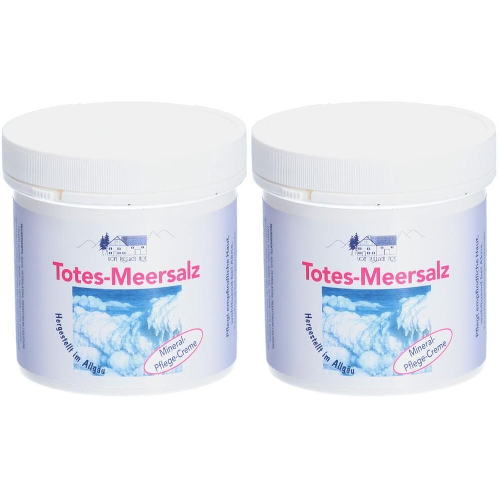 Zwei weiße Tiegel mit Deckel. Aufschrift: Totes-Meersalz, Mineral Pflege-Creme. Logo mit Haus und Wolken. Aufschrift: Hergestellt im Allgäu.