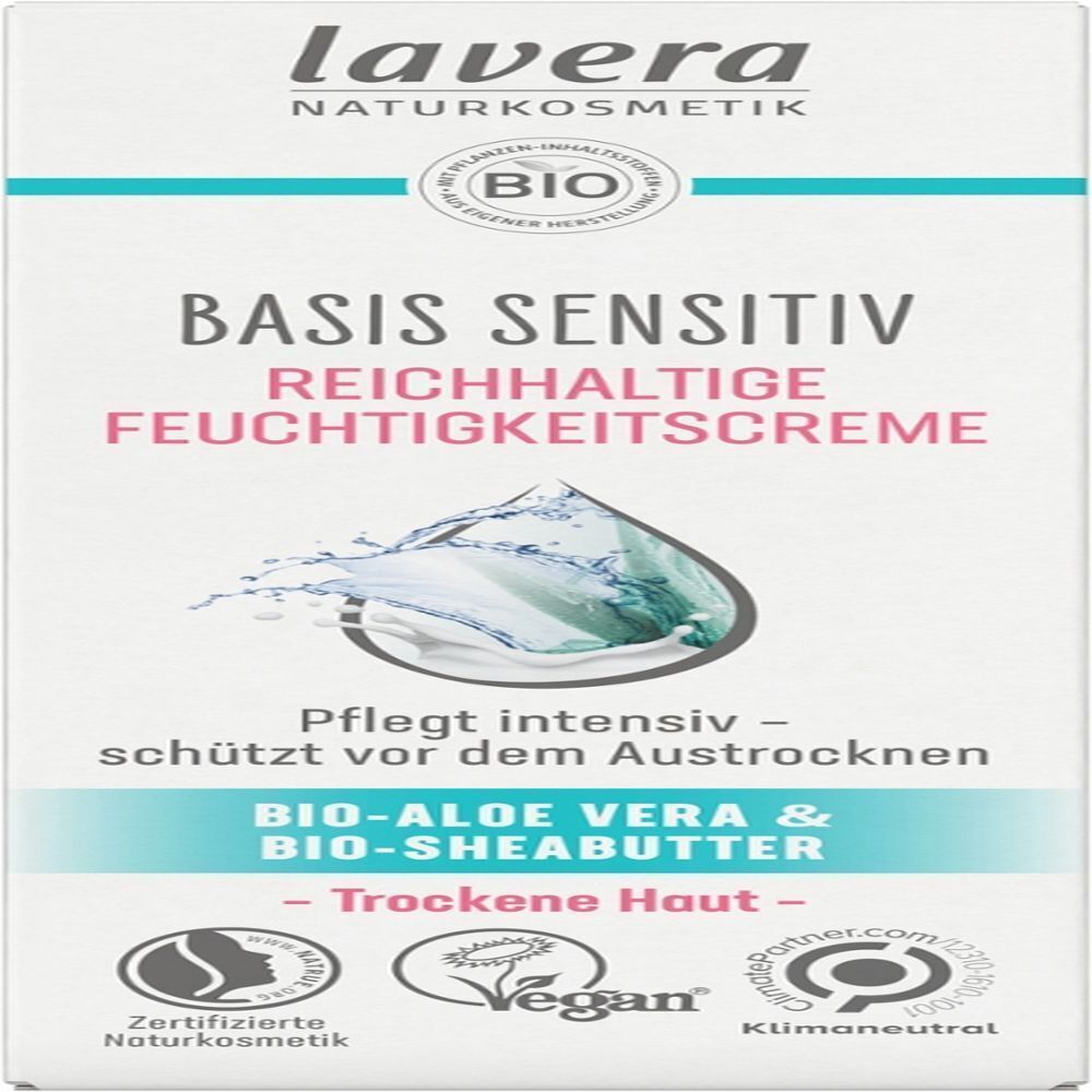 Weißer Karton mit Text: "lavera BASIS SENSITIV REICHHALTIGE FEUCHTIGKEITSCREME". Logo: Bio-Siegel, Vegan-Siegel. Text: "Trockene Haut".