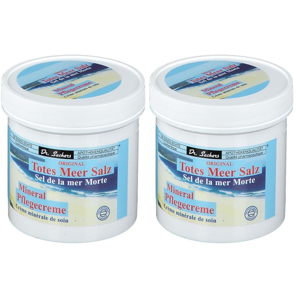 Zwei weiße Tiegel mit Deckel. Aufschrift: Totes Meer Salz Pflegecreme. Blaue Etiketten mit Wellenmuster und Produktinformationen.