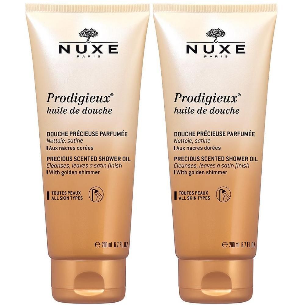 Zwei Tuben Duschöl. Beige-goldene Farbe, Schriftzug NUXE, Prodigieux, huile de douche. Text in Französisch und Englisch.