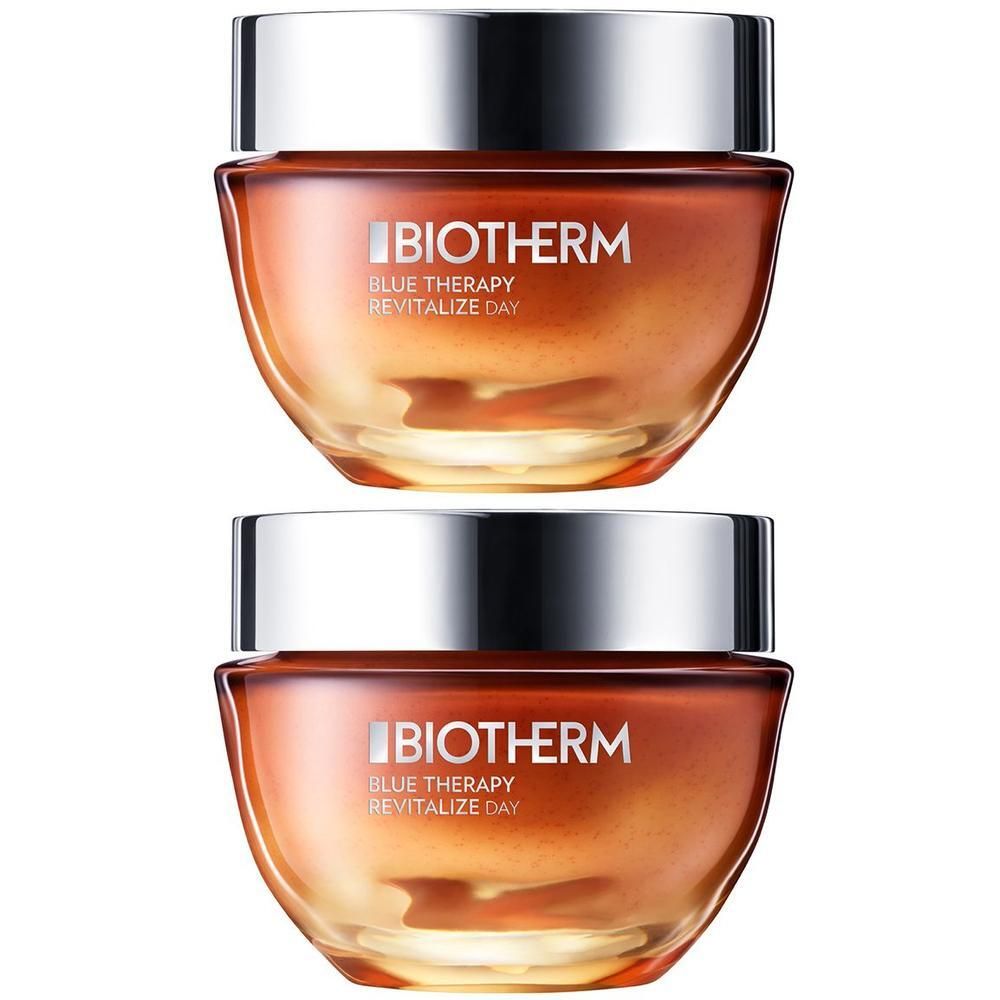 Zwei Tiegel BIOTHERM Revitalize Day Anti-Aging Tagespflege. Glasbehälter mit silbernem Deckel. Orangefarbener Inhalt.