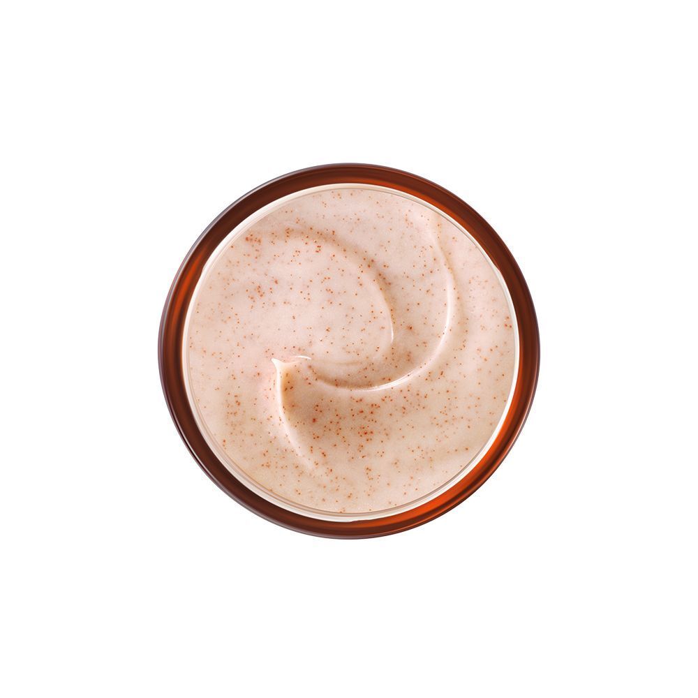 Draufsicht auf Creme in einem Tiegel. Cremefarbene Creme mit kleinen braunen Partikeln. Runde Form.