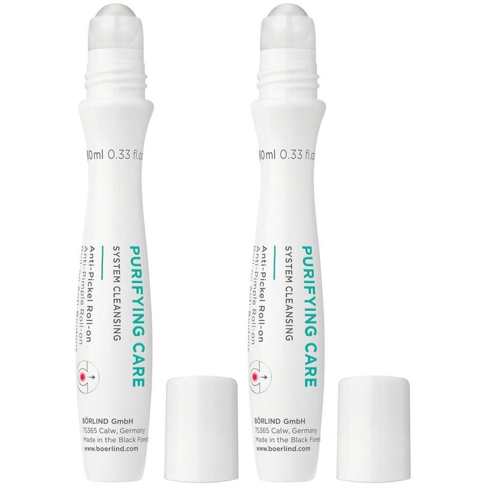 Zwei weiße Roll-on-Flaschen für das Gesicht mit Applikator und Kappe. Beschriftung: 'PURIFYING CARE SYSTEM CLEANSING Anti-Pickel Roll-on'.