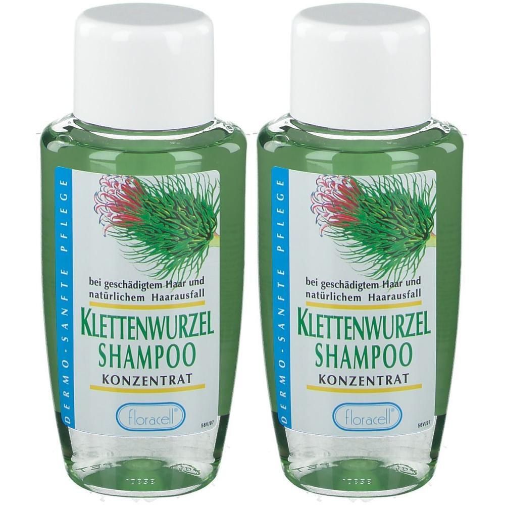Zwei Flaschen Klettenwurzel Shampoo. Auf den Etiketten sind Produktnamen, Logos und Text abgebildet. Weiße Deckel, grüne Flüssigkeit.