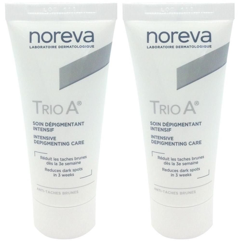 Zwei Tuben Noreva Trio A. Weiße Tuben mit grauen Akzenten. Text: Trio A, Soin dépigmentant intensif, Reduziert dunkle Flecken.