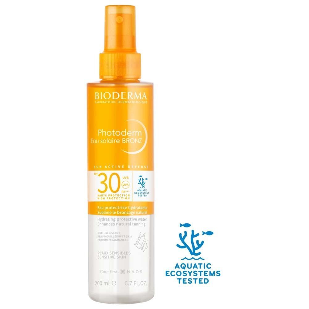 BIODERMA Photoderm Eau solaire BRONZ SPF 30 Spray. Orangefarbener Sprühkopf, transparente Flasche. Text: Photoderm, SPF 30, 200 ml. Aquatische Ökosysteme getestet.
