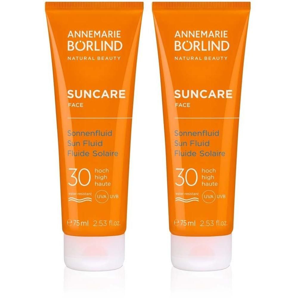 Zwei Tuben ANNEMARIE BÖRLIND FACE Sun fluid LSF 30. Orangefarbene Tuben mit weißem Deckel. Produktnamen und Details sind aufgedruckt.