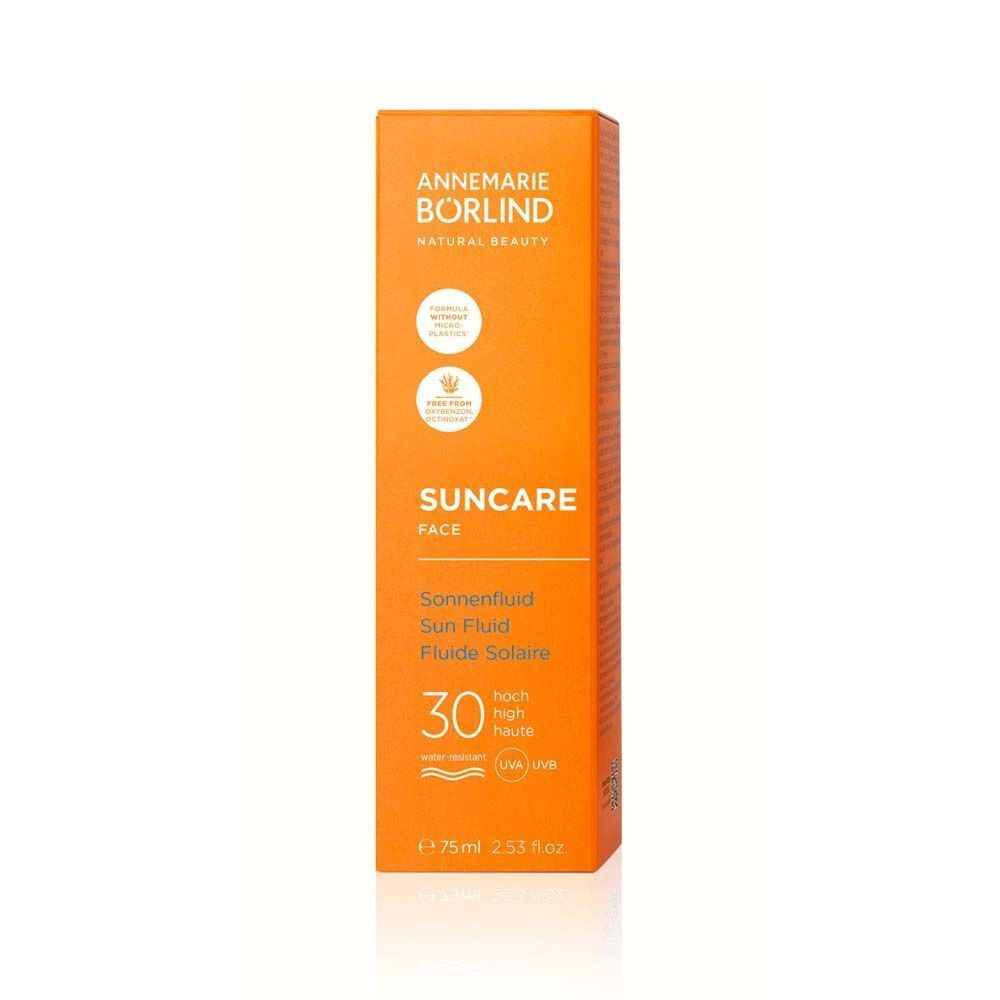 ANNEMARIE BÖRLIND FACE Sun fluid LSF 30 in Verpackung. Orangefarbene Verpackung mit Text. Text: Sonnenschutz, Gesicht, 30 LSF.