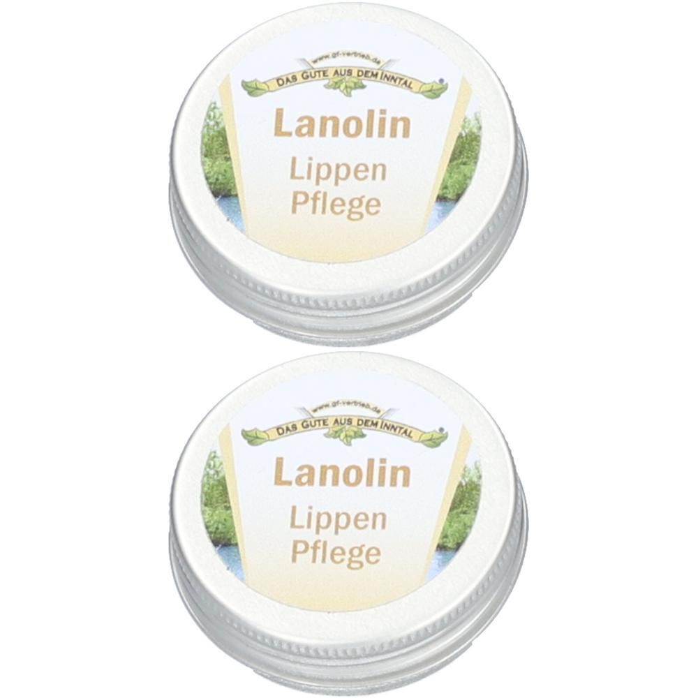 Zwei runde Metallbehälter mit Deckel. Auf dem Deckel steht "Lanolin Lippen Pflege".