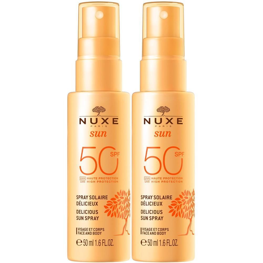 Zwei Sonnensprays mit Sprühkopf. Aufschrift: NUXE Sun, LSF 50, Spray Solaire Délicieux, Visage et Corps, e 50 ml 1.6 FL.OZ.