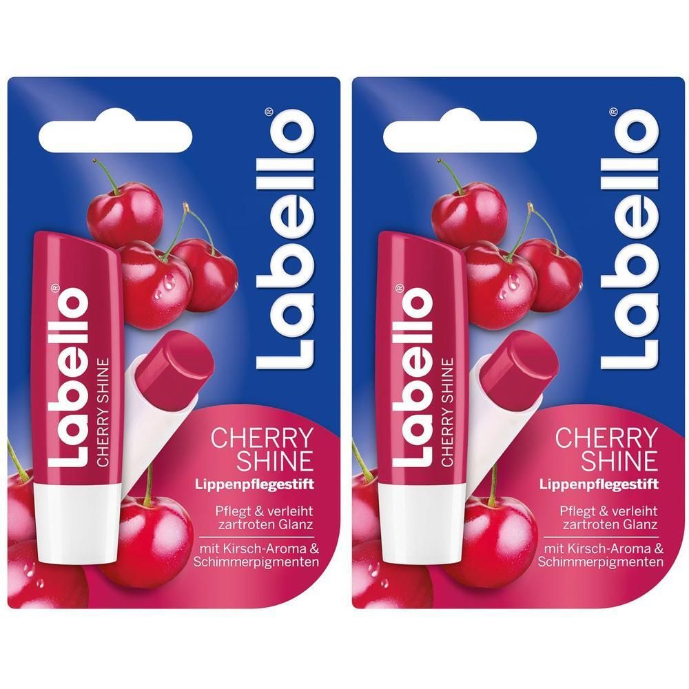Zwei Labello Cherry Shine Lippenpflegestifte in Blisterverpackung. Kirschabbildung und Produktname auf der Verpackung.