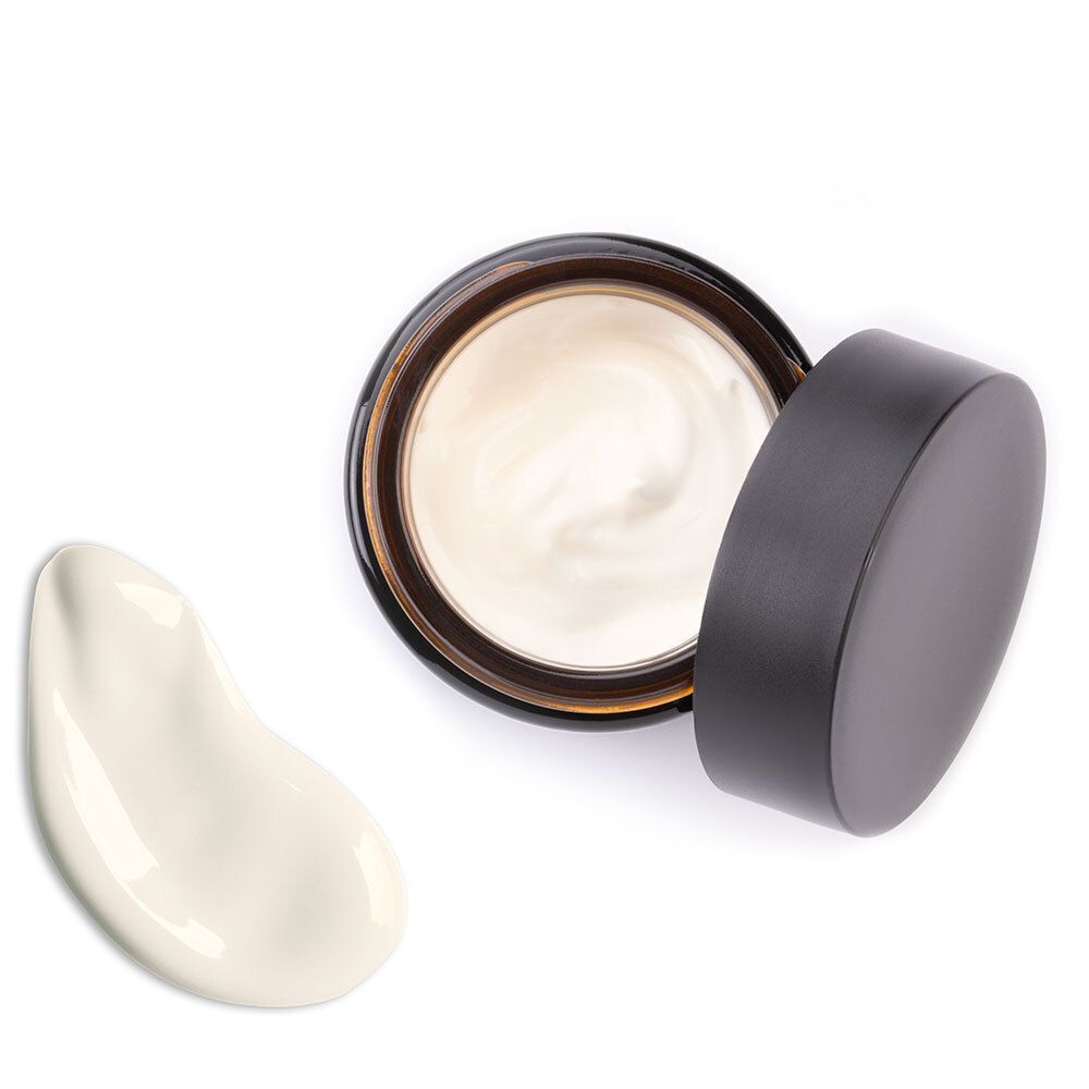 Creme-Tiegel, Deckel daneben. Creme-Klecks daneben. Aufschrift: ANTI-FALTEN ARGAN TAGESCREME, DR.SCHELLER.