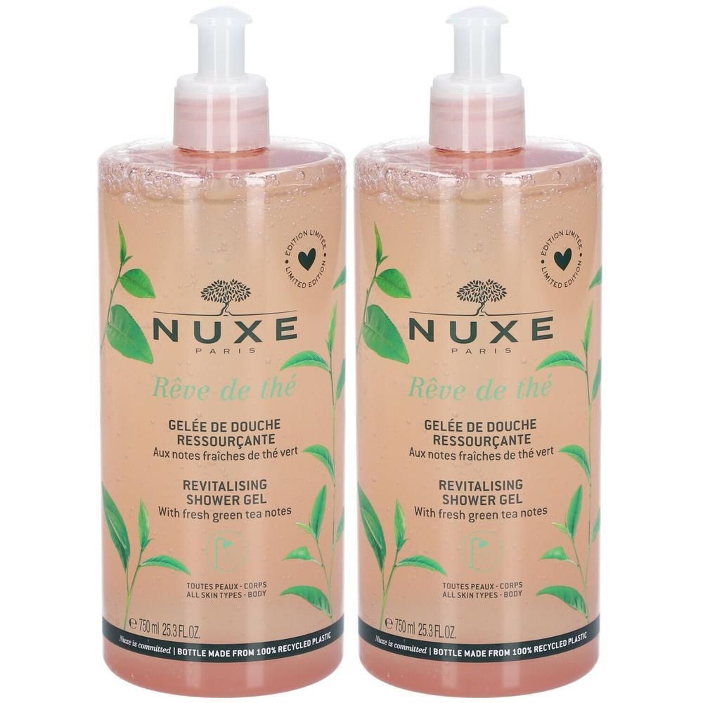 Zwei Flaschen Duschgel mit rosa Flüssigkeit. Aufschrift: NUXE, Rêve de thé, Revitalising Shower Gel. Grüne Teeblätter-Illustrationen.