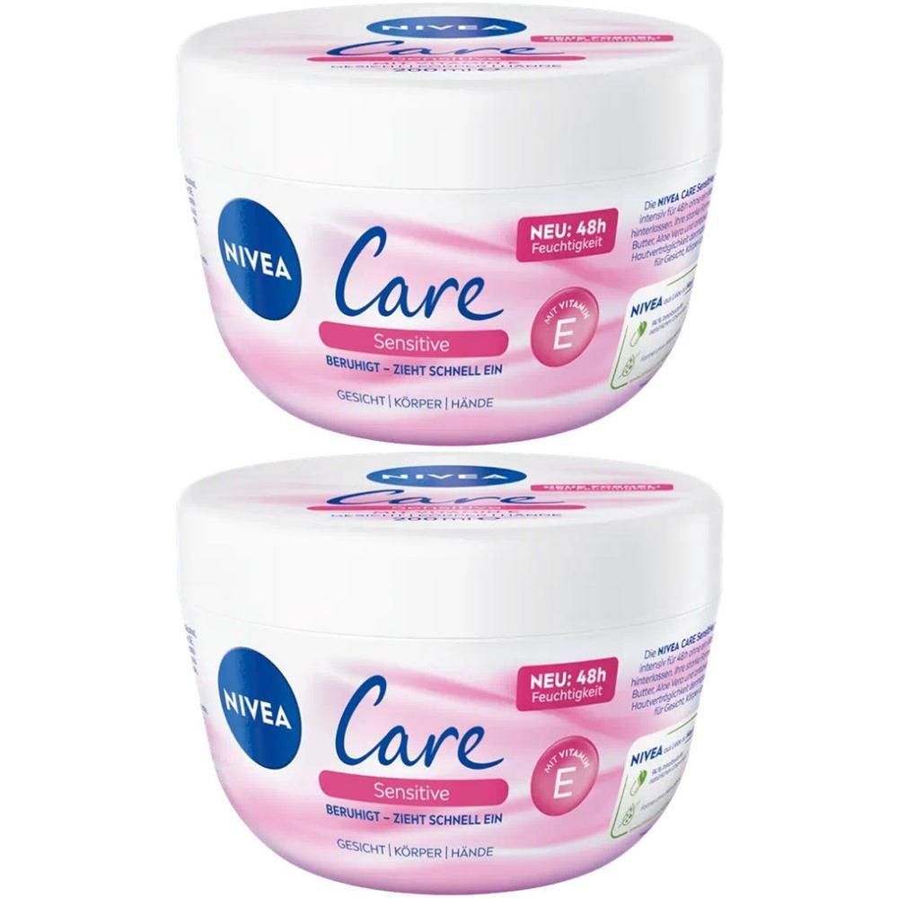 Zwei weiße Tiegel NIVEA Care Sensitive Creme. Blaue Logo-Kreise, rosa Akzente, Schriftzüge. "NEU: 48h Feuchtigkeit" und "E".