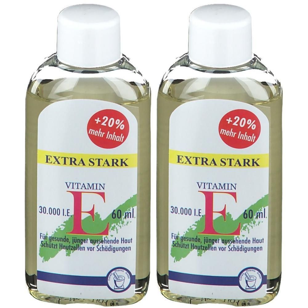 Zwei Flaschen mit Vitamin E Öl. Aufschrift: EXTRA STARK, VITAMIN E, 30.000 I.E., 60 ml. Roter Aufkleber: +20% mehr Inhalt. Klare Flüssigkeit.