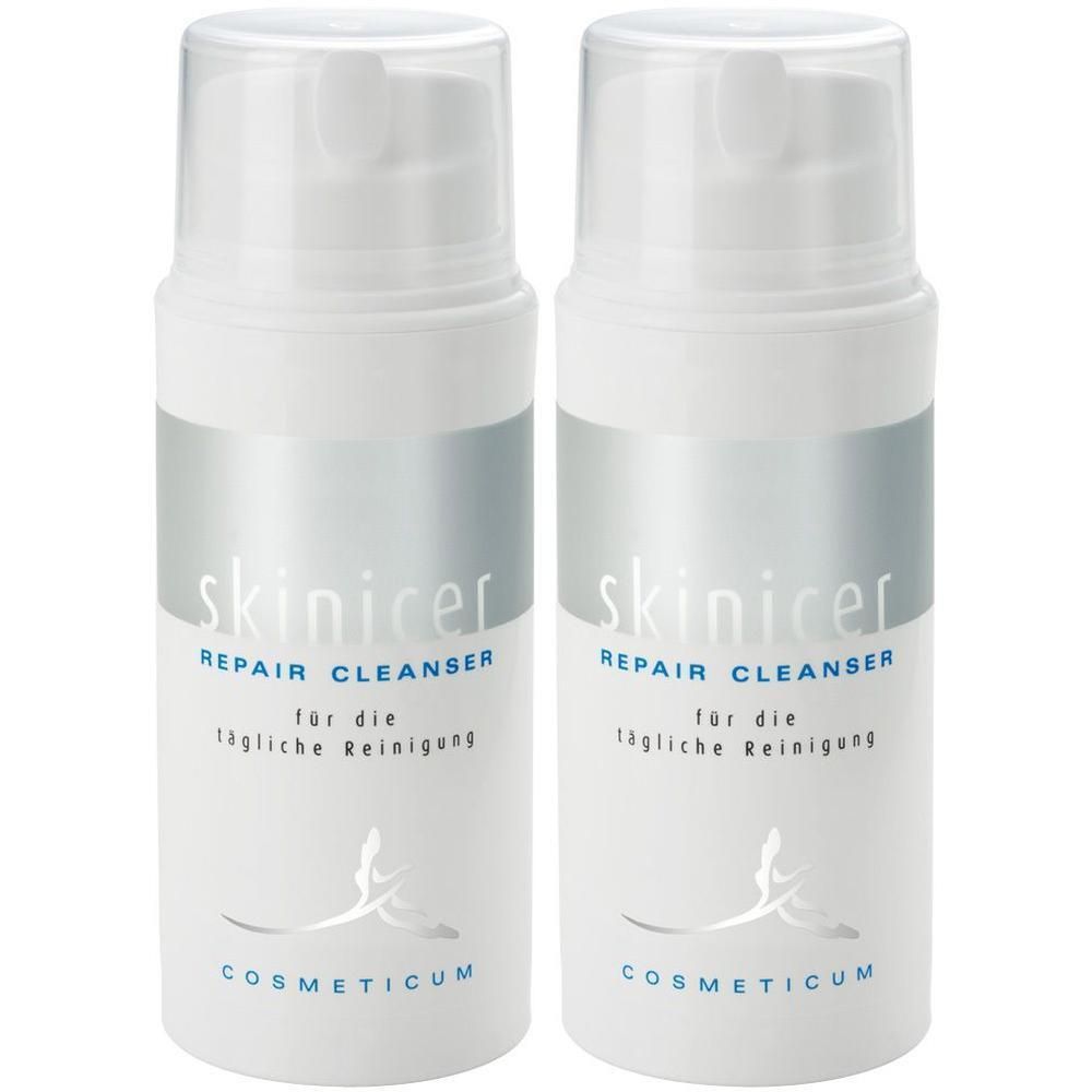 Zwei weiße Flaschen mit Pumpaufsatz. Aufschrift: skinicer REPAIR CLEANSER. Text darunter: für die tägliche Reinigung. Logo COSMETICUM.