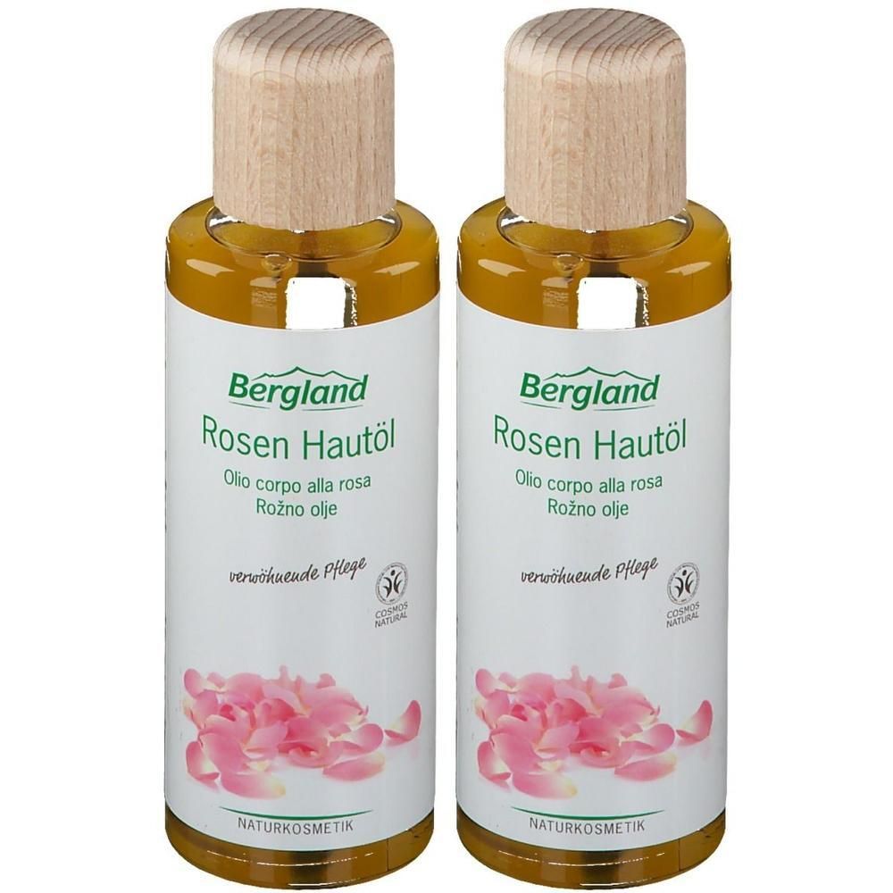 Zwei Flaschen mit Holzdeckel. Aufschrift: Bergland Rosen Hautöl. Etikett mit Rosenblüten. Naturkosmetik-Siegel.