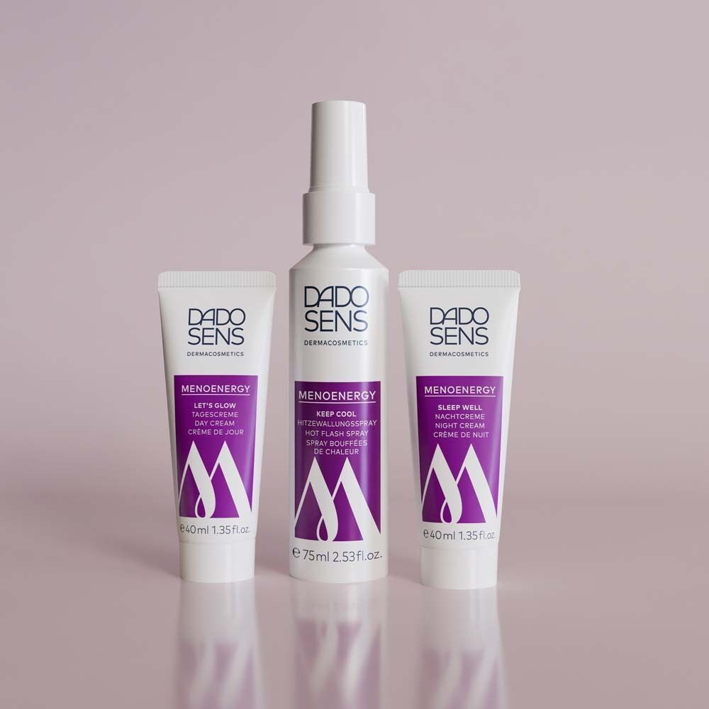 Drei DADOSENS Produkte: Nachtcreme, Tagescreme und Flash Spray. Weiße Tuben und Flasche mit lila Schrift.