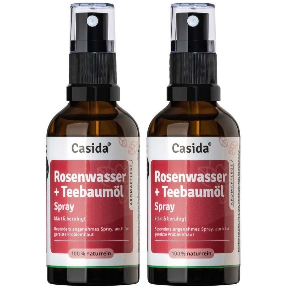 Zwei Flaschen Casida® Rosenwasser + Teebaumöl Spray. Braune Glasflaschen mit schwarzem Sprühkopf und weißem Etikett.