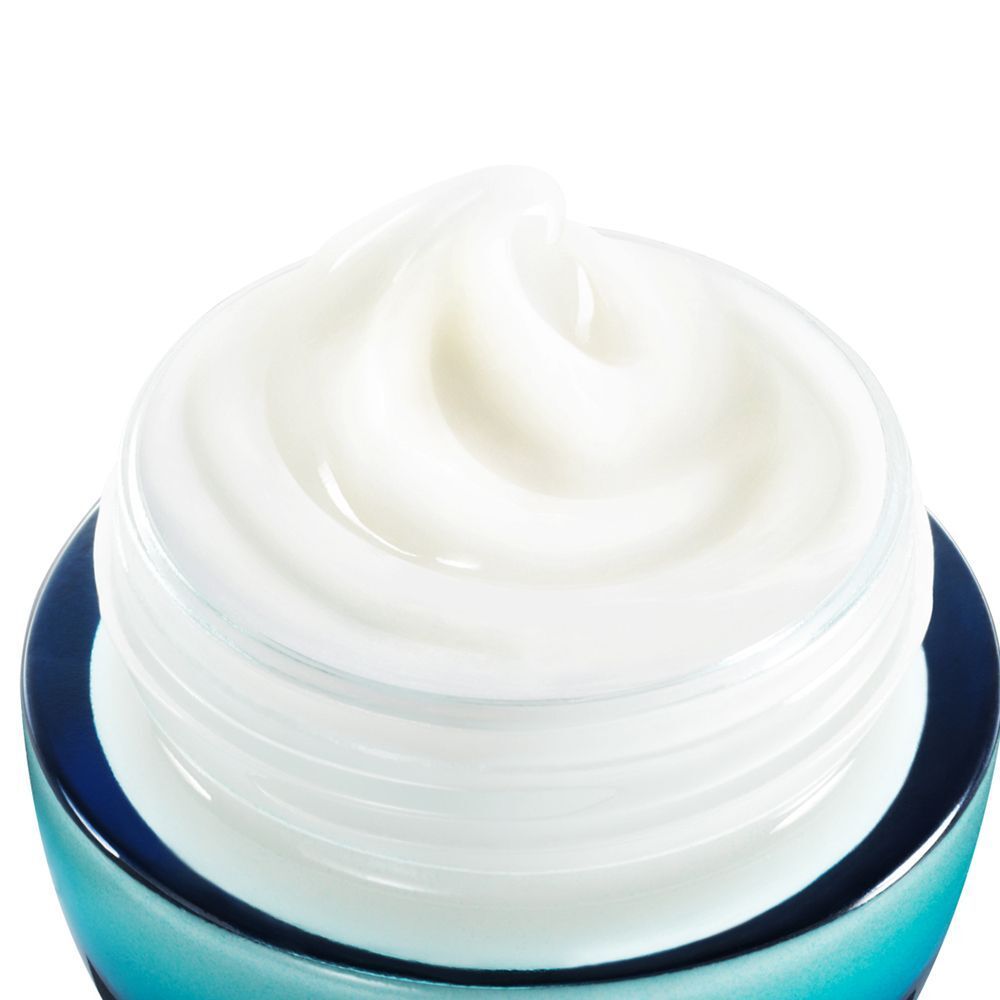 Nahaufnahme eines geöffneten Tiegels. Weiße Creme mit gewirbelter Oberfläche. Der Tiegel hat einen blauen Rand.
