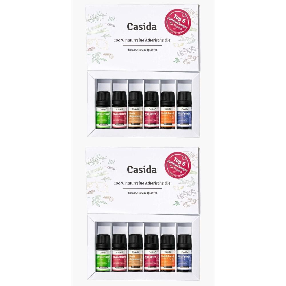Zwei Produktverpackungen mit je sechs kleinen Flaschen ätherischer Öle. Jede Flasche hat eine andere Farbe. Auf der Verpackung steht "Casida".
