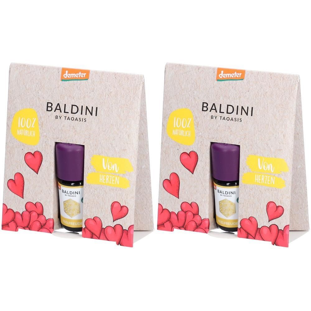 Zwei Geschenkverpackungen mit BALDINI-Logo, je eine kleine Flasche mit lila Verschluss. Aufdrucke: 100% natürlich, Von Herzen.