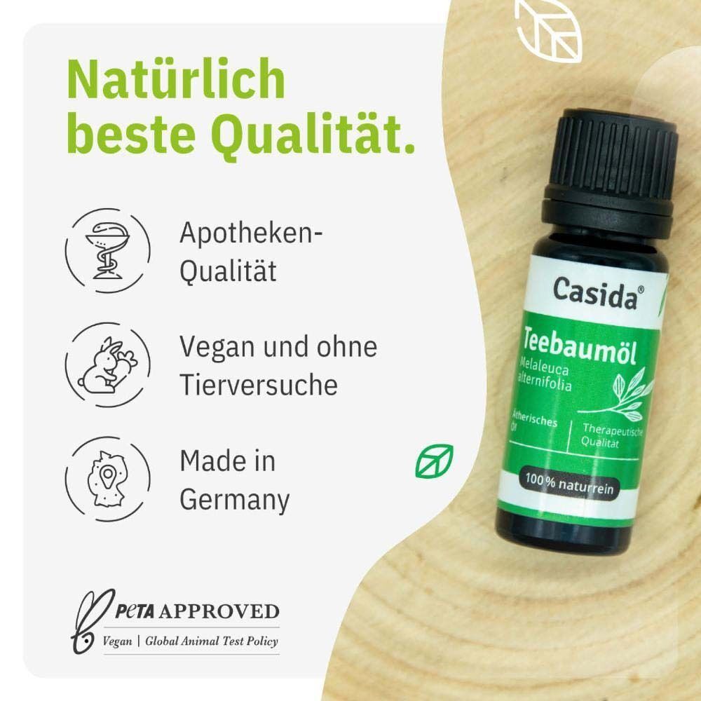 Flasche Casida® Teebaumöl auf Holz. Apotheken-Qualität, vegan und ohne Tierversuche, hergestellt in Deutschland. PETA-Logo.