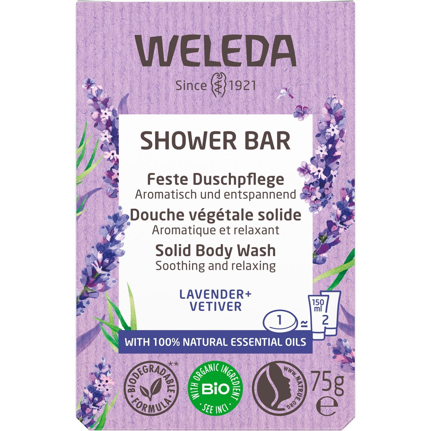 Lilafarbene Produktverpackung mit Lavendel-Illustrationen. Text: "WELEDA SHOWER BAR", "LAVENDER+VETIVER", und Zertifizierungen.