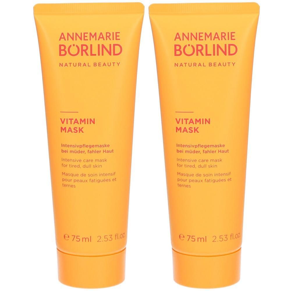 Zwei Tuben Vitamin Mask. Orangefarbene Verpackung mit Produktnamen und Markenschriftzug. Enthält Text in Deutsch, Englisch und Französisch.