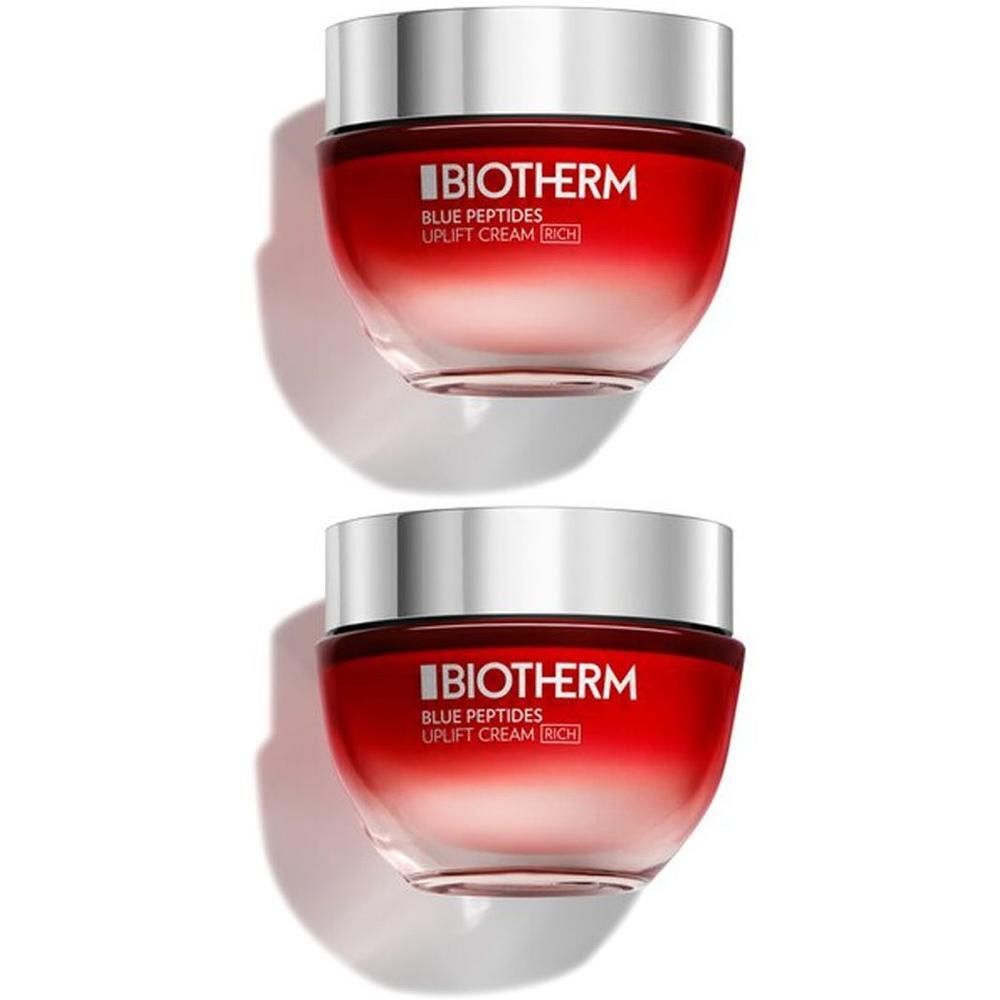 Zwei Tiegel mit silbernen Deckeln und roten, transparenten Gläsern. Aufschrift: BIOTHERM, BLUE PEPTIDES UPLIFT CREAM RICH.