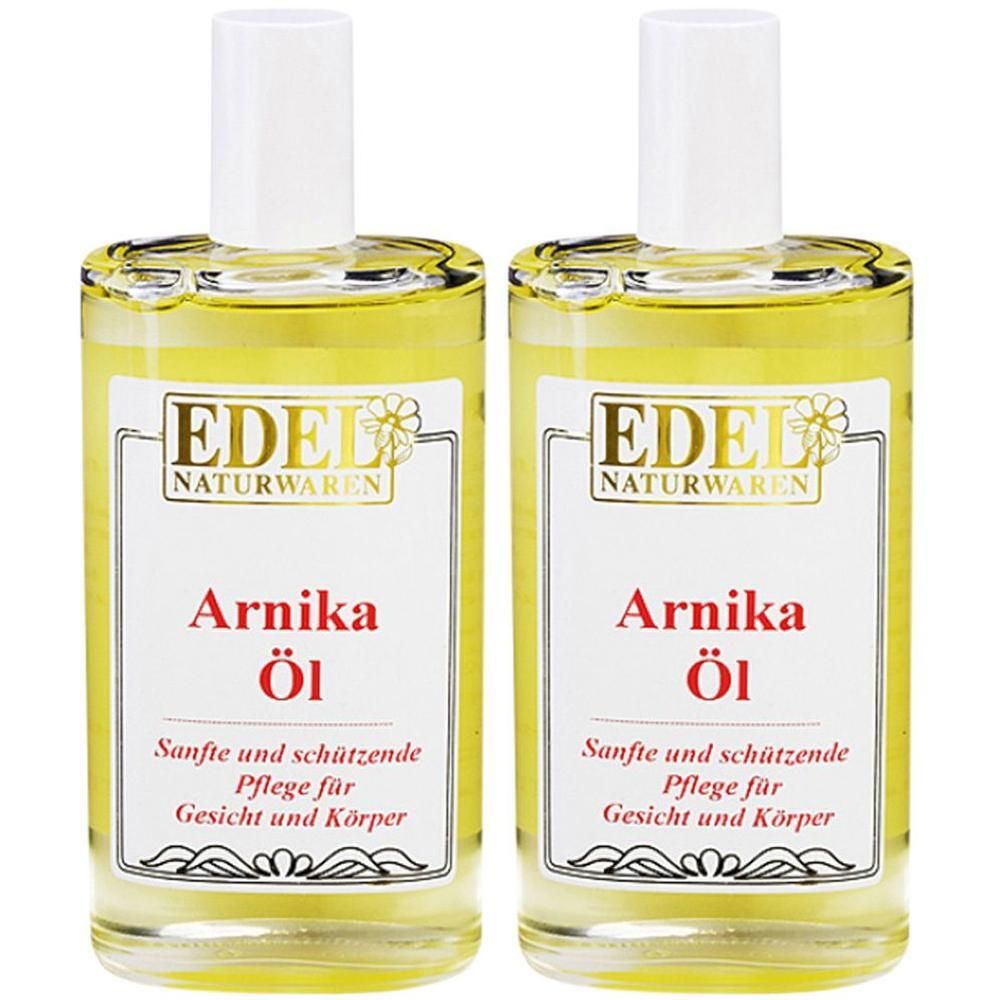 Zwei Flaschen Arnika-Öl. Klare Glasflaschen mit weißem Deckel. Etikett mit Produktname und Marke EDEL NATURWAREN.