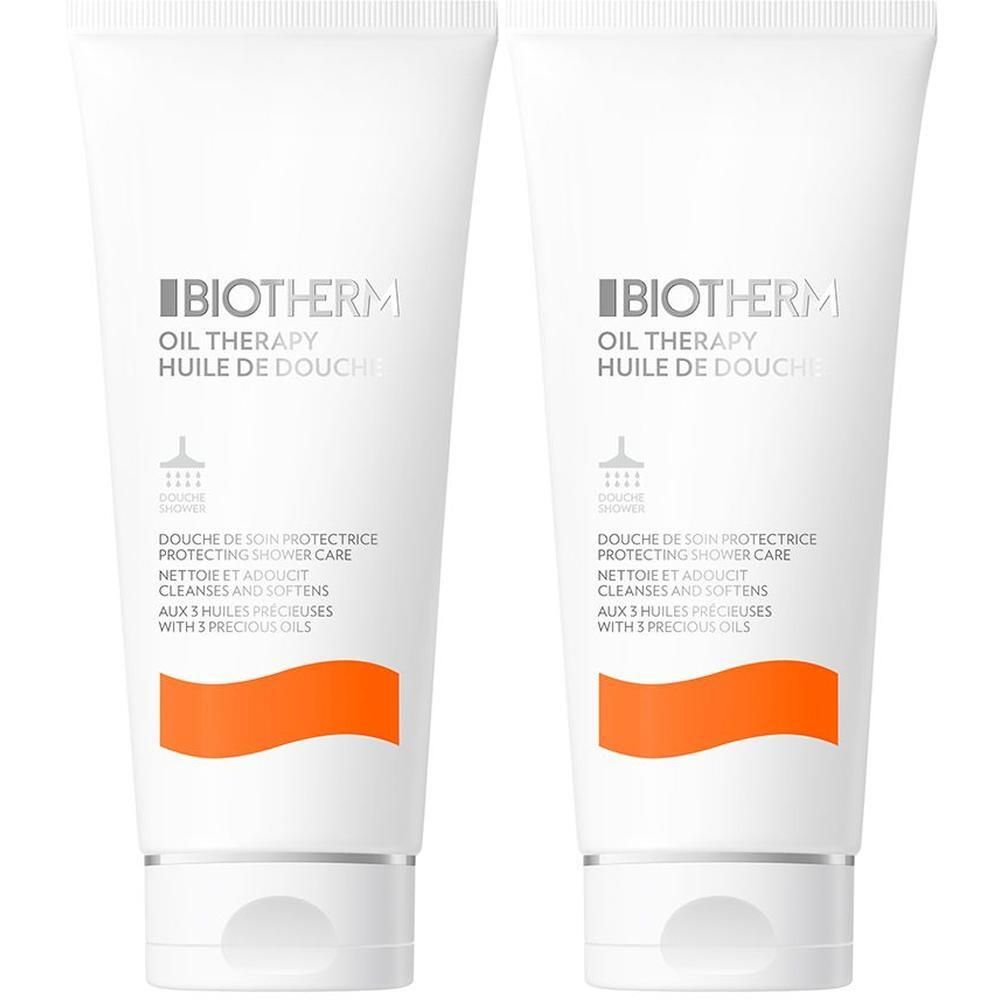 Zwei Tuben BIOTHERM Oil Therapy Duschöl. Weiße Tuben mit grauer Schrift und orangefarbenem Akzent. Produktname und Beschreibung sichtbar.