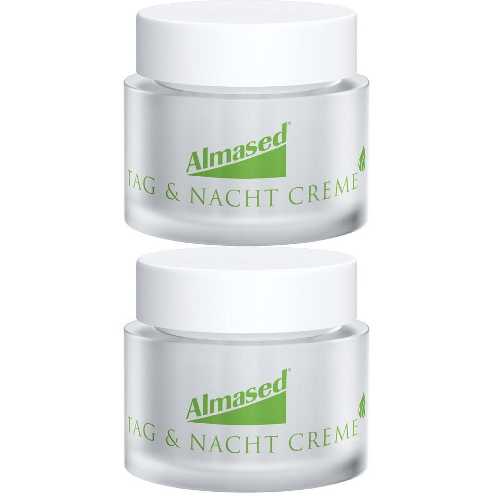 Zwei Cremetiegel mit weißen Deckeln. Auf den Tiegeln steht "Almased Tag & Nacht Creme".