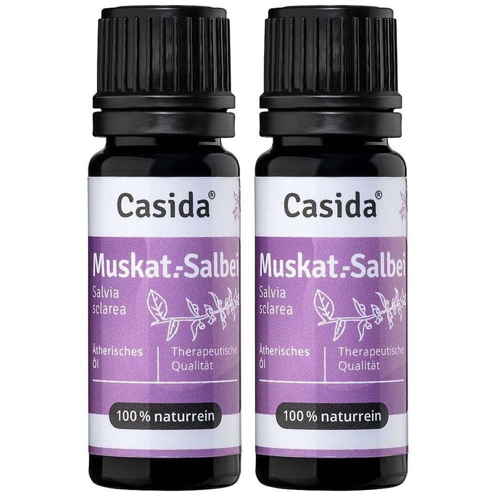 Zwei Flaschen Casida® Muskat.-Salbeiöl. Violette Etiketten mit Produktnamen und Logo. Schwarze Deckel.