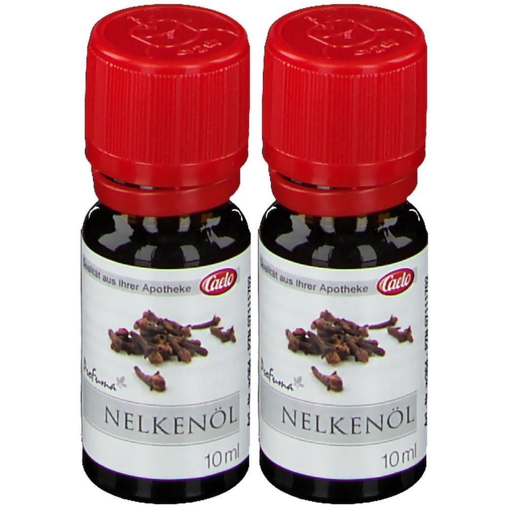 Zwei Flaschen Nelkenöl mit rotem Verschluss. Aufschrift: Nelkenöl, 10ml, Caelo. Daneben Nelken.