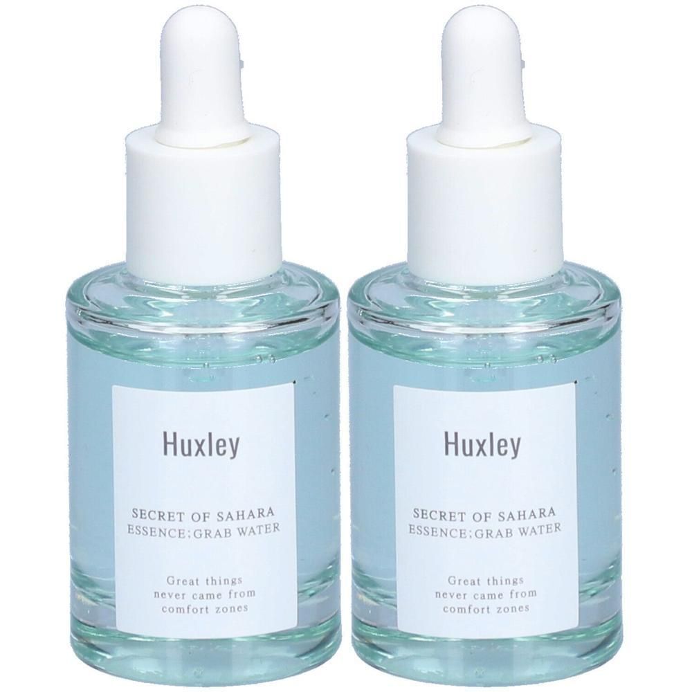 Zwei Glasflaschen mit Pipettenaufsatz. Auf den Etiketten steht "Huxley" und "SECRET OF SAHARA ESSENCE:GRAB WATER".