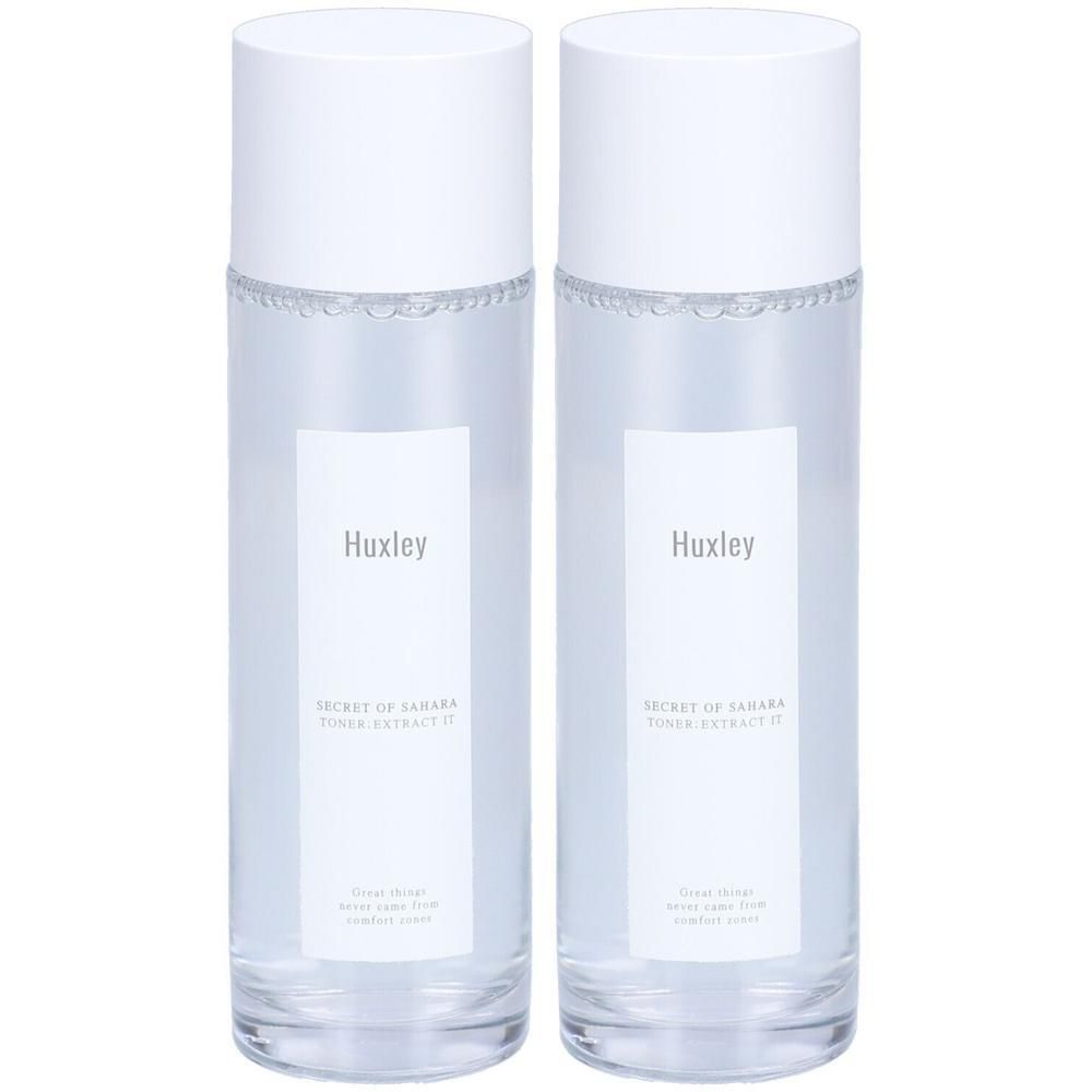 Zwei transparente Flaschen mit weißen Deckeln und Etiketten. Auf den Etiketten steht "Huxley" und "Toner Extract It".
