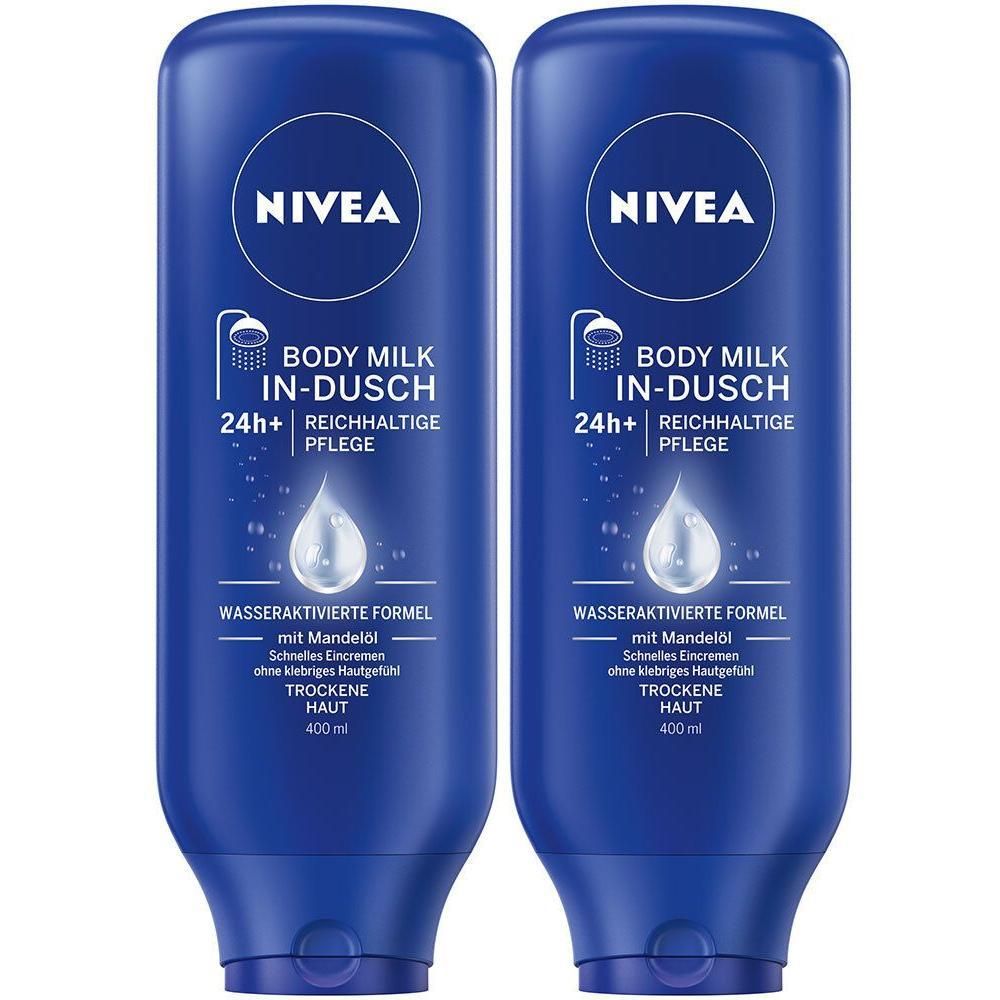 Zwei blaue Flaschen NIVEA BODY In-Dusch Milk. Aufschrift: BODY MILK IN-DUSCH, 24h+ reichhaltige Pflege, wasseraktivierte Formel. Mit Mandelöl. 400 ml.
