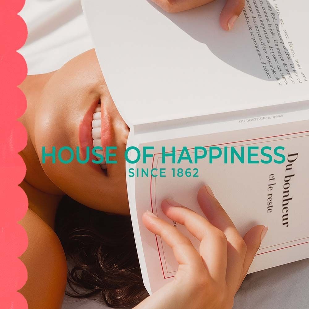 Frau liest Buch. Text: House of Happiness, Since 1862.