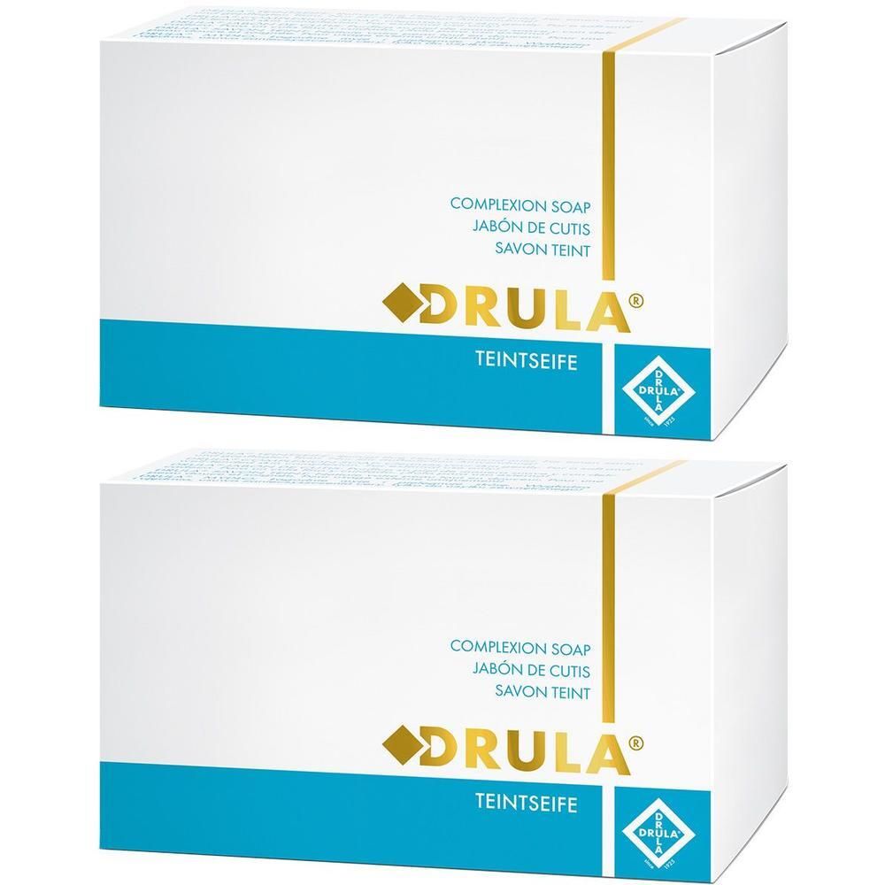 Zwei weiße Kartons mit blauer Fläche und goldfarbenen Akzenten. Aufschrift: DRULA Teintseife, Complexion Soap, Jabón de cutis, Savon teint.