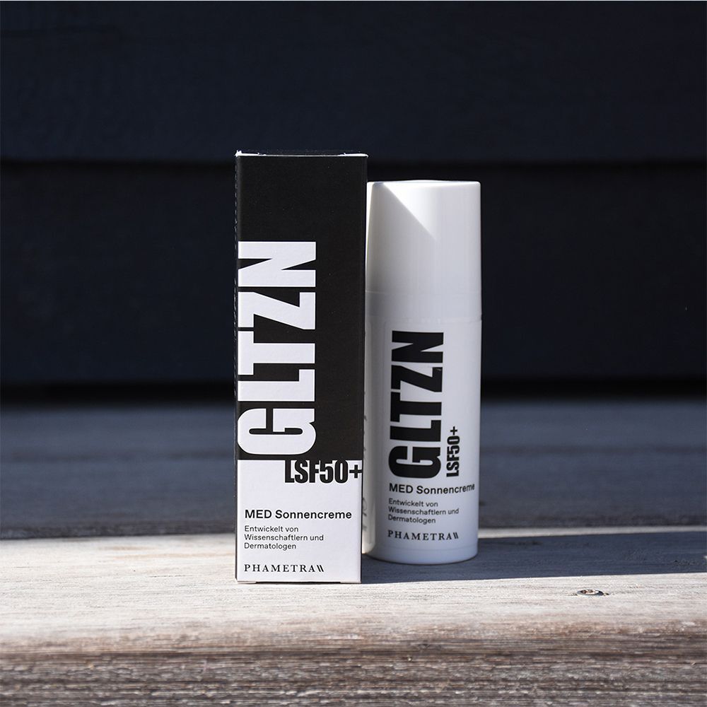 GLTZN MED Sonnencreme LSF 50+ Flasche und Verpackung auf Holzoberfläche.