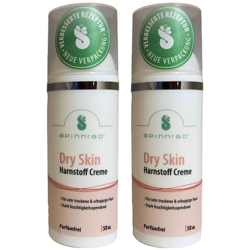 Zwei Cremes mit Spinnrad®-Logo. Aufschrift: Dry Skin Harnstoff Creme. Mit grünem Siegel: Verbesserte Rezeptur, neue Verpackung. 50 ml.