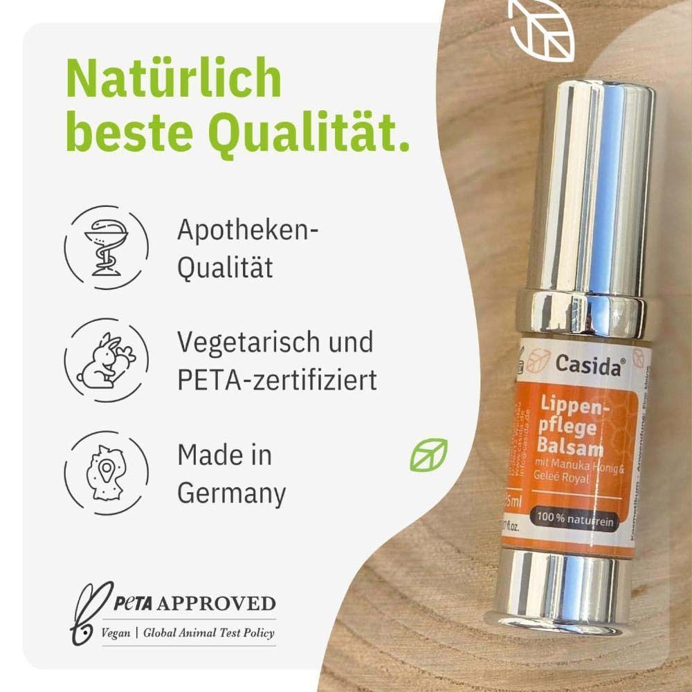 Eine Lippenpflege Balsam-Tube. Aufschrift: Casida, Lippenpflege Balsam mit Manuka Honig & Gelee Royal, 100% naturrein. Apotheken-Qualität, vegetarisch, PETA-zertifiziert.