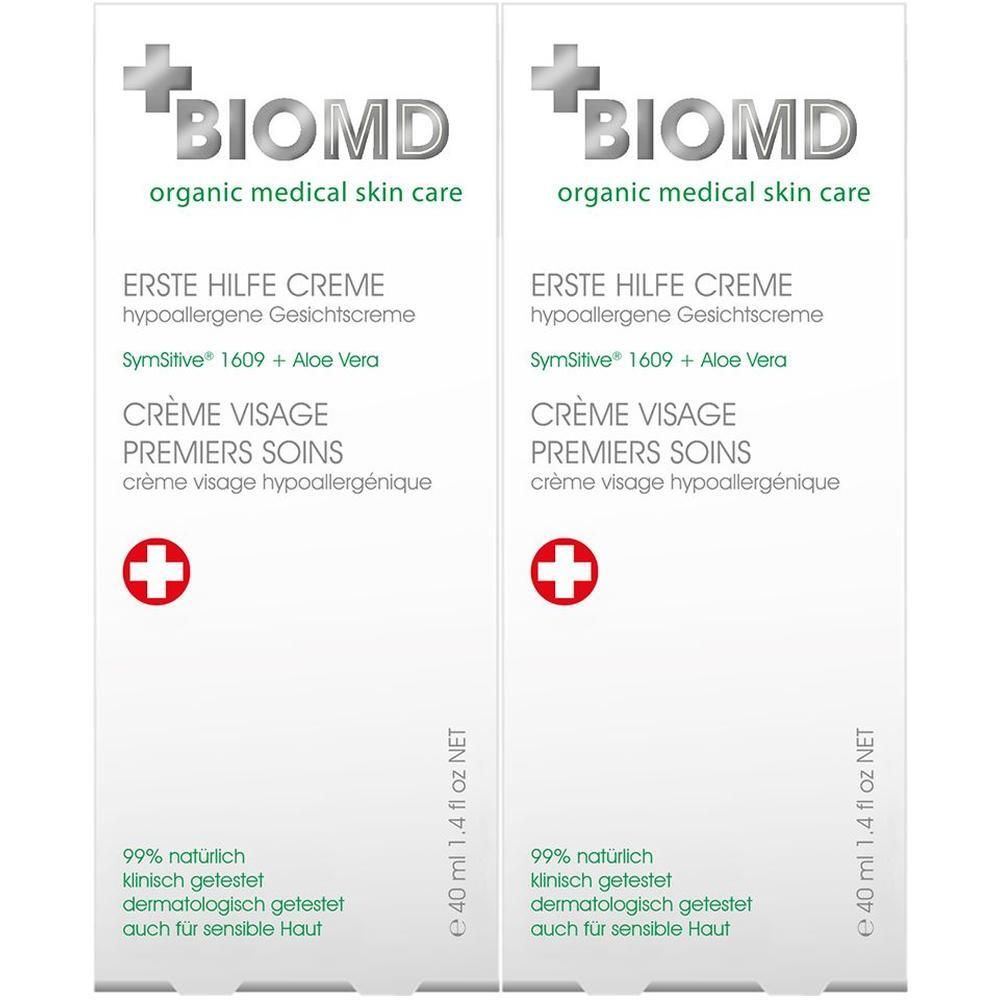 Zwei weiße Kartons mit BIOMD-Logo und Text. Enthält Erste Hilfe Creme, 99% natürlich, dermatologisch getestet.