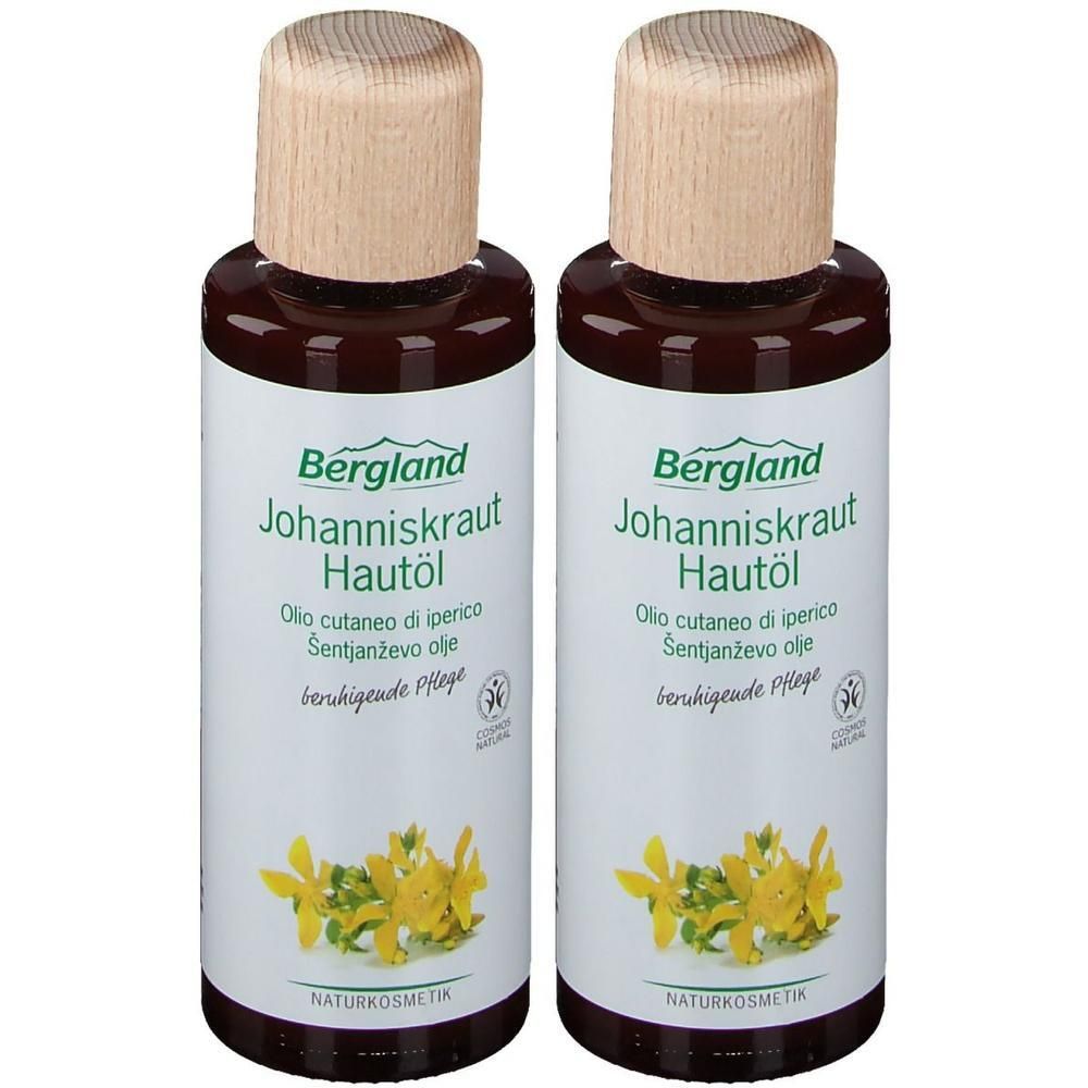 Zwei Flaschen Johanniskraut Hautöl mit Holzdeckel. Aufschrift: Bergland, Johanniskraut Hautöl, Naturkosmetik. Gelbe Blüten abgebildet.