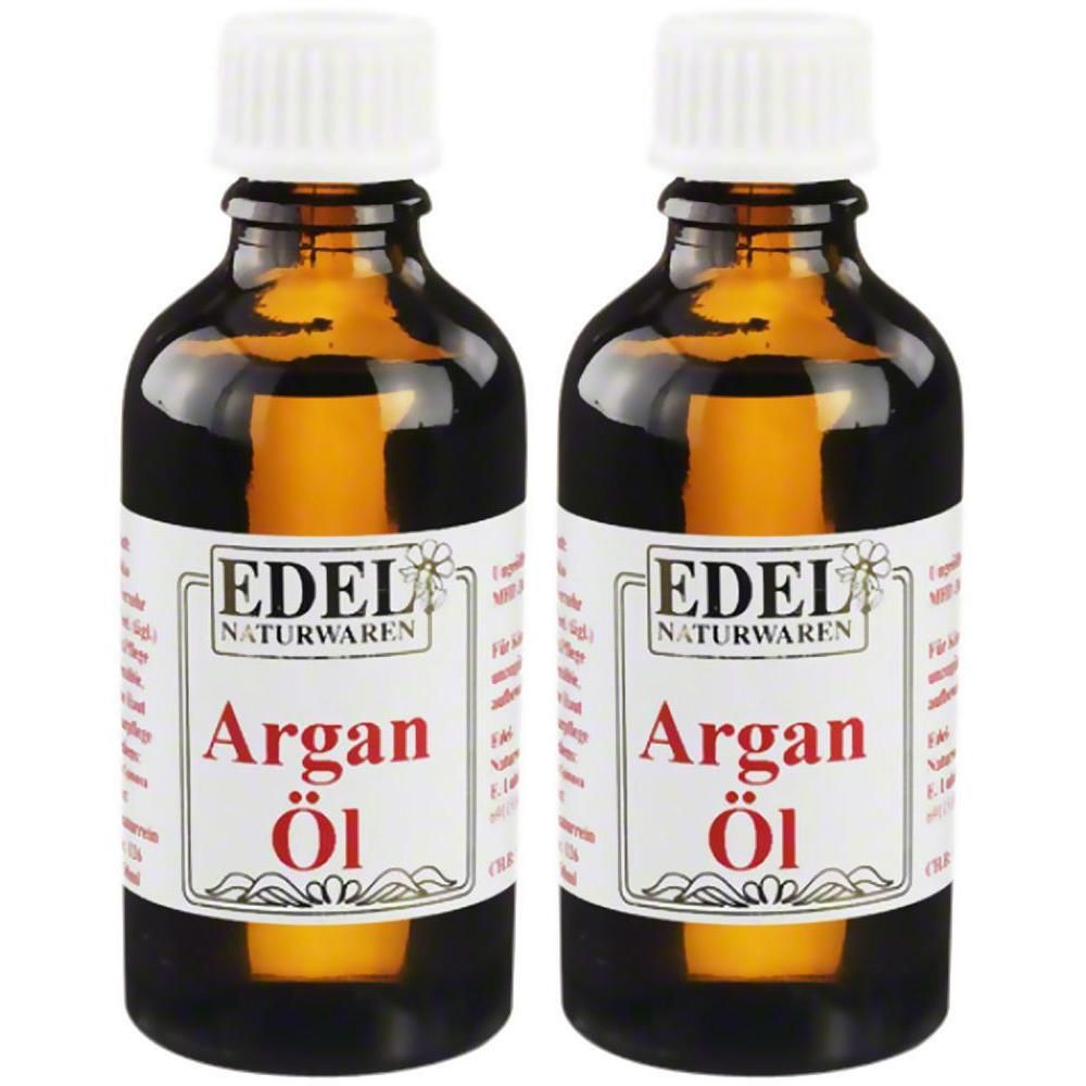 Zwei Flaschen Argan-Öl. Braune Glasflaschen mit weißem Deckel und Etikett. Aufschrift: EDEL NATURWAREN, Argan Öl.