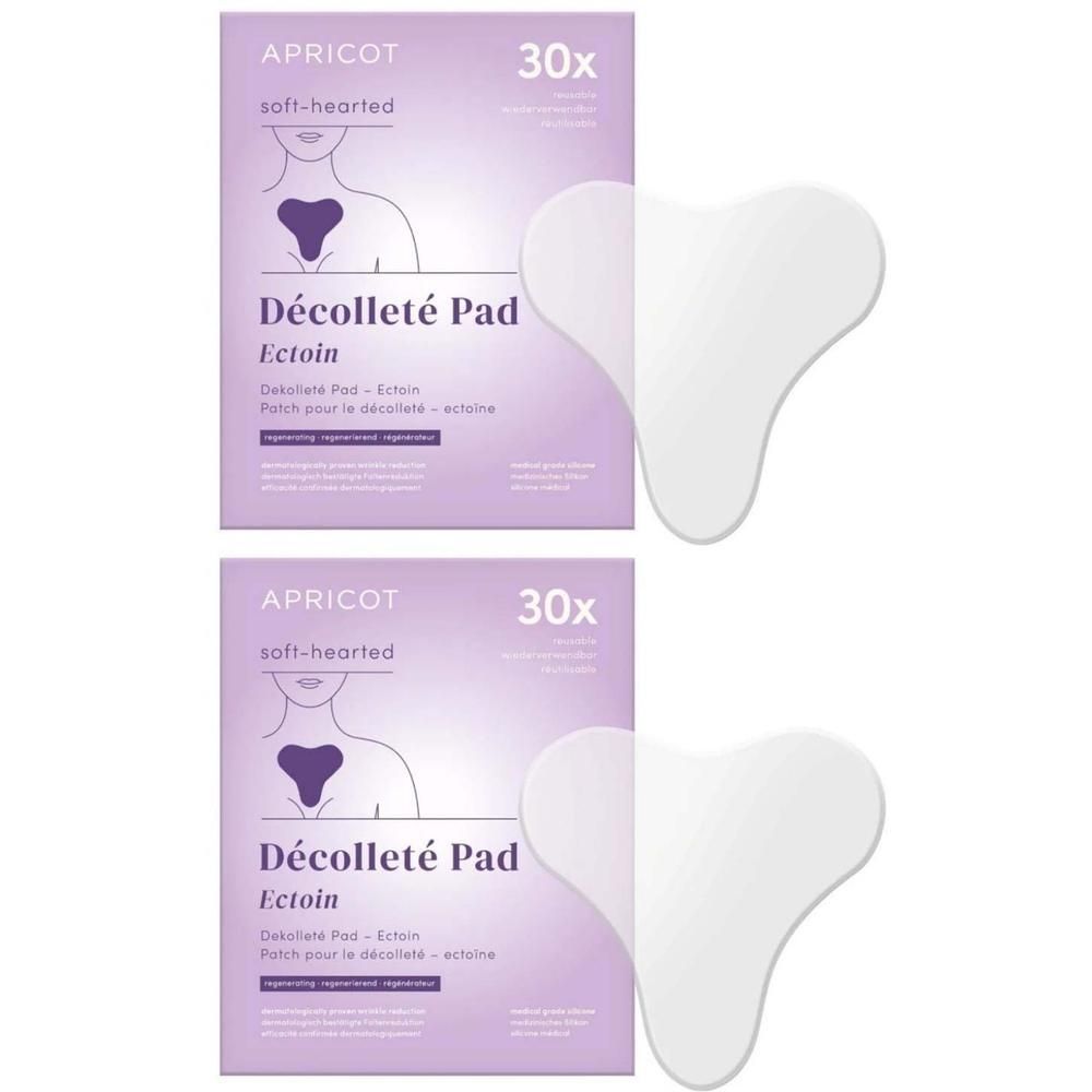 Zwei Packungen mit Pads. Aufschrift: APRICOT, Décolleté Pad Ectoin. Daneben zwei herzförmige, transparente Pads.