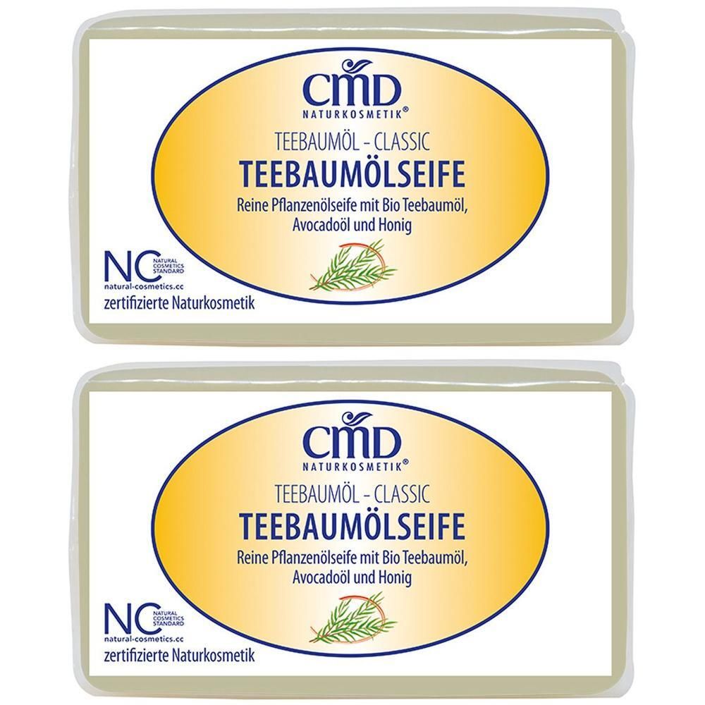Zwei Seifenstücke mit ovalem Logo. Aufschrift: CMD Teebaumölseife. Zertifizierte Naturkosmetik.