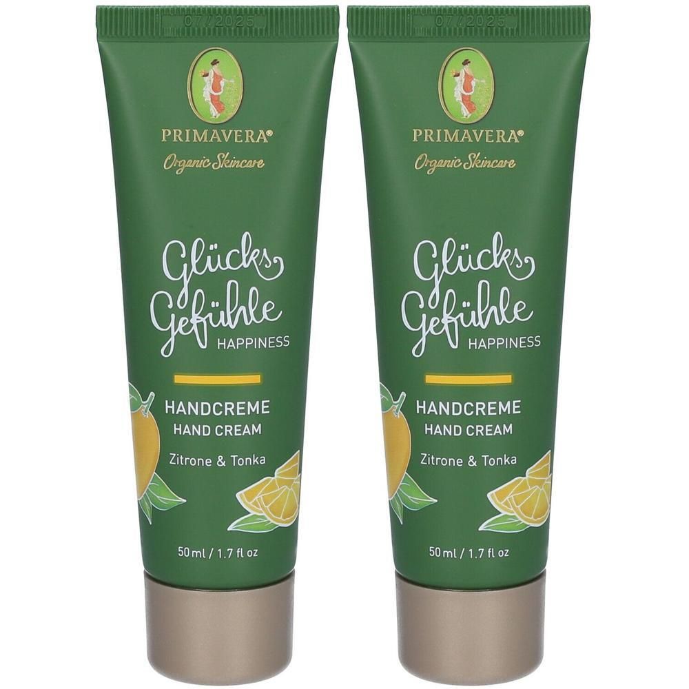 Zwei grüne Handcreme-Tuben. Aufschrift: Glücksgefühle, Handcreme, Zitrone & Tonka. Marke: Primavera. Mit gelben Zitronen-Illustrationen.